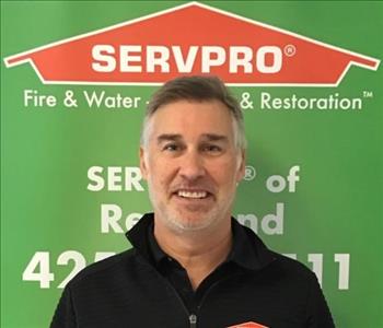 Male owner SERVPRO of Redmond in front of SERVPRO sign